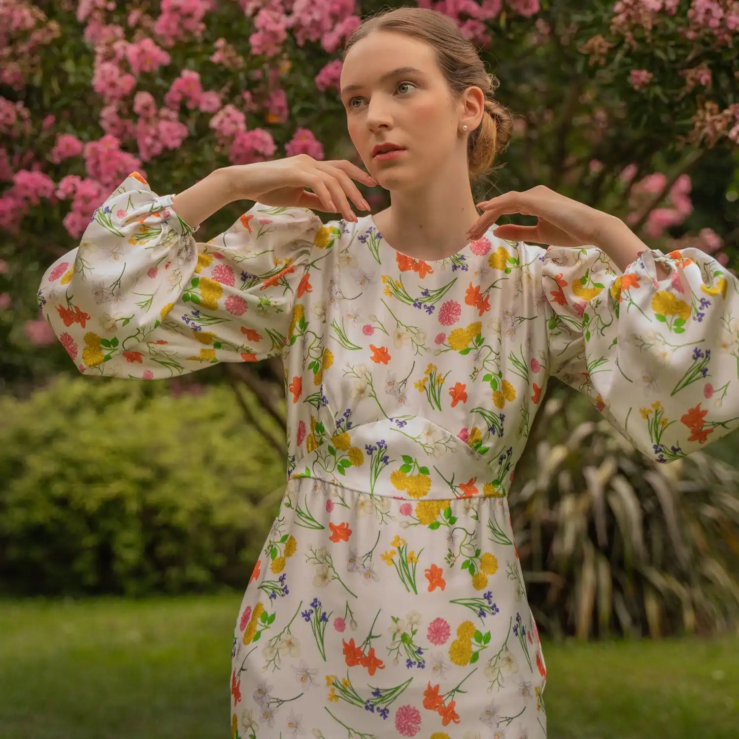 A floral print dress with puff sleeves and a fitted waist.